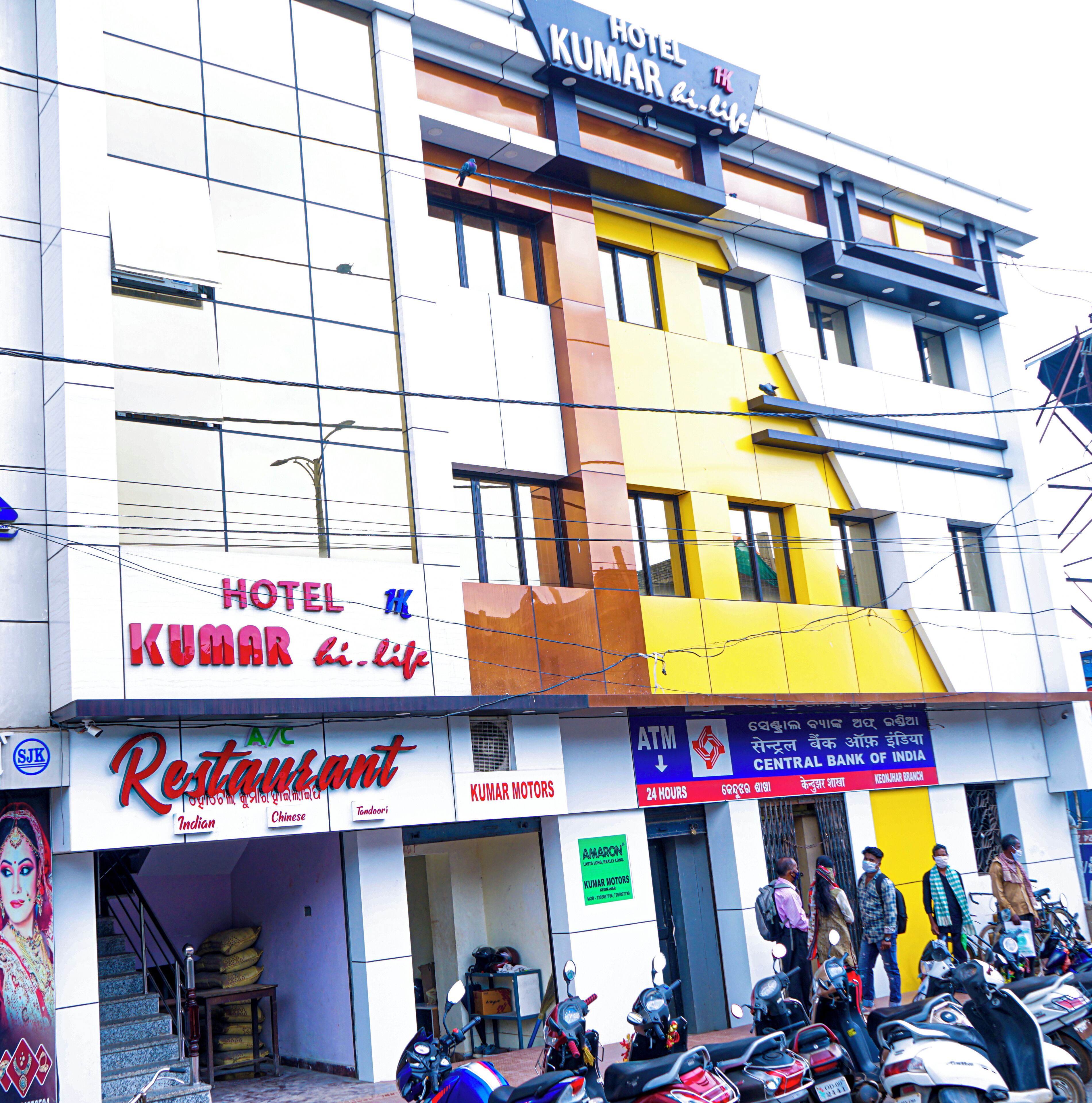 A hotel named 'Hotel Kumar' with a sign indicating '24 hours' service.