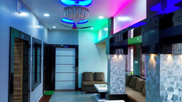 A modern interior with a chandelier, ceiling fan, and seating area. - KUMAR HILIFE (Kendujhar)
