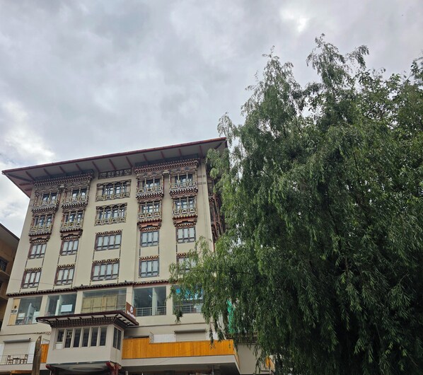 A multi-story building with traditional architectural elements, including ornate balconies and large windows. - The Seva Hotel (Thimphu)