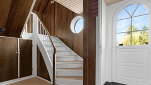 A staircase with wooden walls and white railings leading to a landing. - 5 Star Holiday Home in Lokken (Hirtshals)