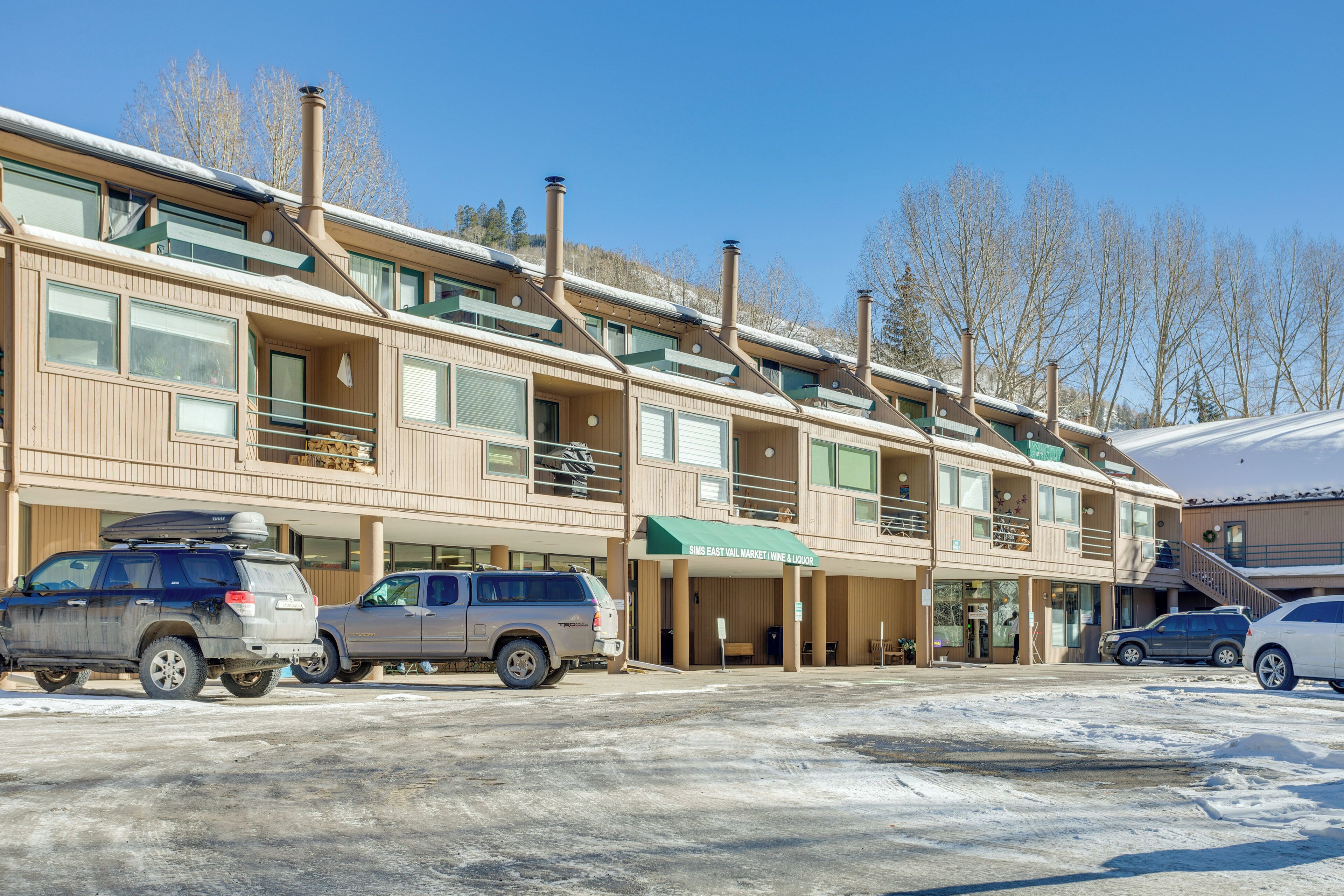 A multi-story hotel with a ski lift visible in the background.