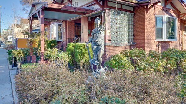 A house with a statue in front, a porch, and a brick exterior. - Half-mi to River Walk: 'rose Cottage' in Truckee! (Reno)