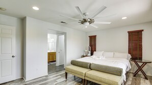 A bedroom with a bed, a bench, a ceiling fan, and a nightstand. - 20 Mi to Old Town San Diego: Stay & Play! (Chula Vista)