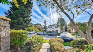 A residential street with houses, parked cars, and a sidewalk leading to a house entrance. - 20 Mi to Old Town San Diego: Stay & Play! (Chula Vista)