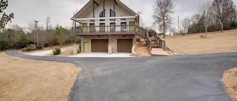 A modern two-story house with a garage, a covered porch, and a driveway leading to the entrance.
