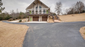A modern two-story house with a garage, a covered porch, and a driveway leading to the entrance. - Shared Boat Dock: Lake Guntersville Hideaway! (Guntersville)