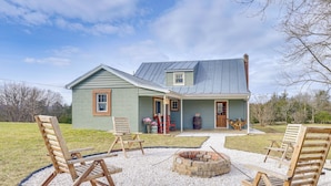 A house with a porch, outdoor seating, and a fire pit. - Grill & Fire Pit: New Market Getaway on 3-acres! (New Market)