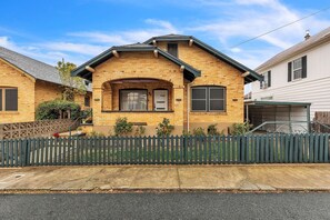 Stunning two-story home with a charming front entrance, attached garage, and beautifully manicured yard.