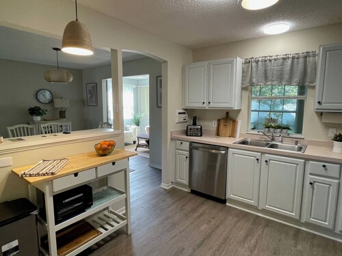 Cozy home w/golf cart, lanai, smart TVs, & prime location near town squares!