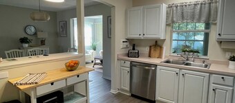 Cozy home w/golf cart, lanai, smart TVs, & prime location near town squares!