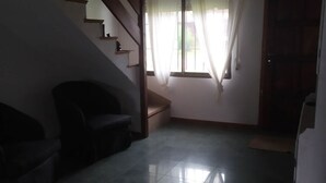 A room with a staircase, a window with sheer curtains, and a tiled floor. - CASA CHALET LAMAR (whole house) (Santa Clara del Mar)