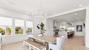 A modern kitchen with a central island, large windows, and a chandelier. - Bikes, Close Beach Access, Gulf View, Private Pool (Inlet Beach)