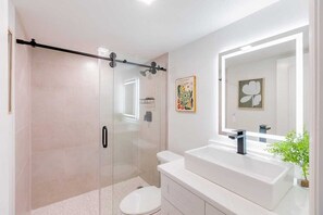 Shower, hair dryer, towels, shampoo