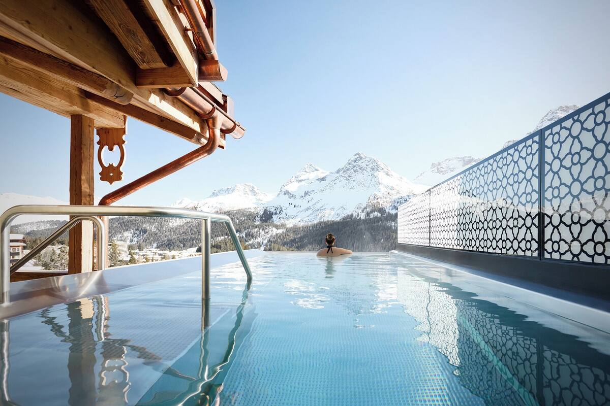 A pool area with a view of snow-capped mountains.