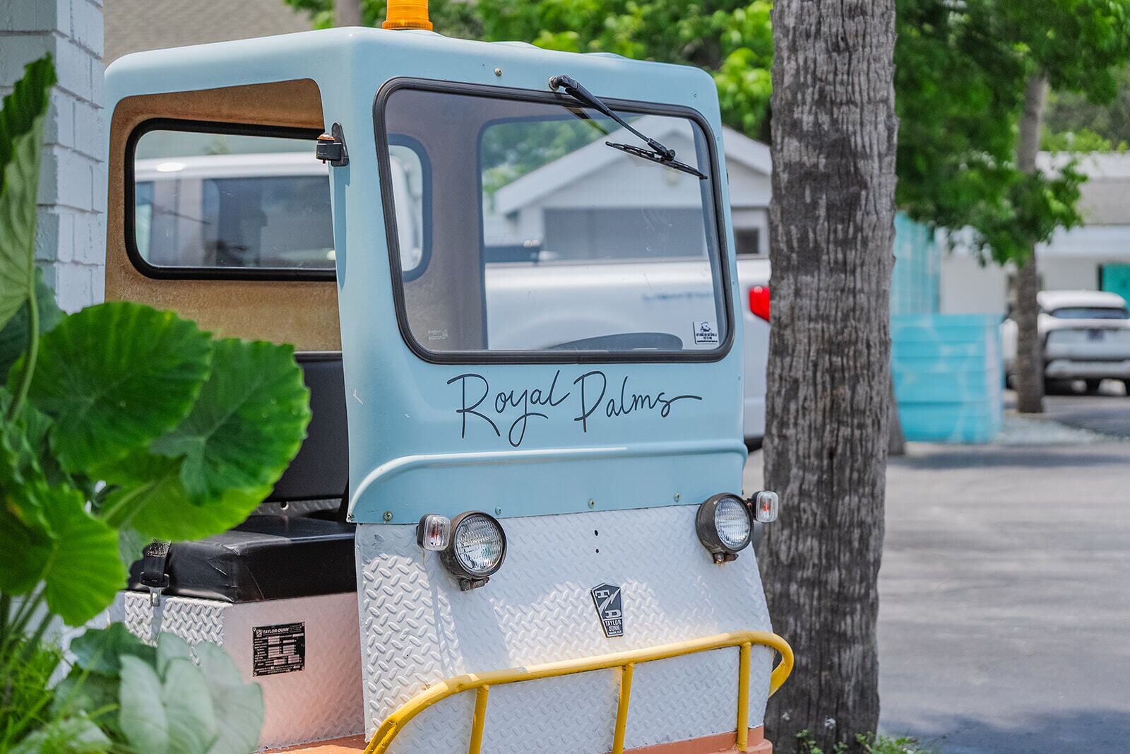 A vintage vehicle with the text "Royal Palms" on the front.