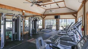 A covered gym with various exercise equipment, including treadmills and weight machines.