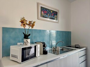 Fridge, microwave, electric kettle, cookware/dishes/utensils