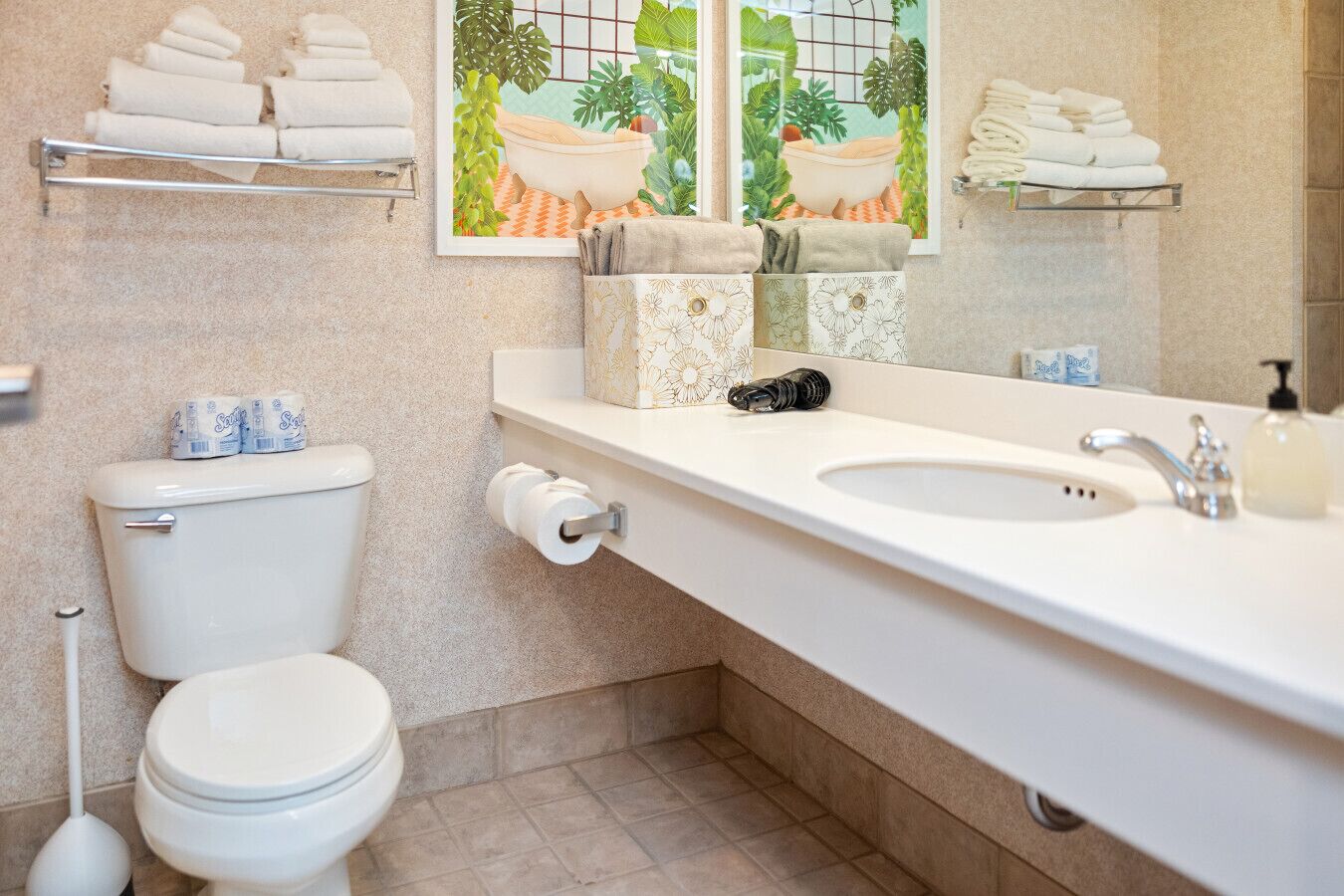 A bathroom with a toilet, sink, and towel rack.