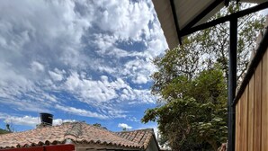 A house with a tiled roof, stone foundation, and a paved patio. - Escape to paradise in Paipa, Boyacá in this beautiful Casa Rural San Cipriano!🏡 (Paipa)