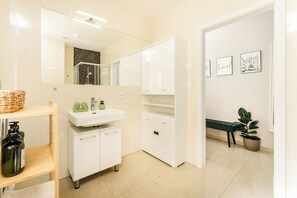 Shower, hair dryer, towels, soap