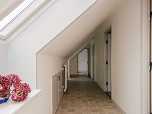 A narrow, well-lit hallway with a skylight, leading to multiple doors. - 6 Person Holiday Home in Ringkobing (Ringkobing)