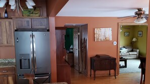 A kitchen with a granite countertop, a stainless steel refrigerator, and a wooden cabinet. - Charming Country farmhouse (Fredonia)