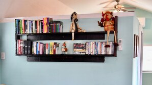 A living room with a bookshelf, a small table, and a sofa.