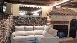 A stone wall, a sofa, and a fireplace.