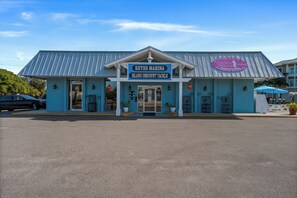 A Keyes Marina Island Discount Tackle building with a blue exterior and a metal roof. - Unique Canal Home in The Best Location (Holmes Beach)