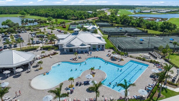 A resort with a large swimming pool, tennis courts, and a golf course.