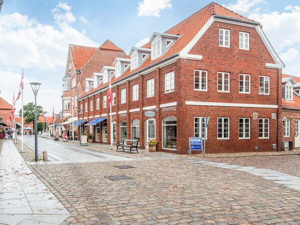 A red brick building with multiple windows and a sign that reads 'anneberg.'