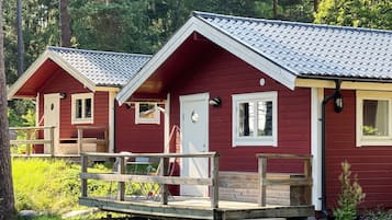 Cabins nestled among the trees, each with a cozy porch and an outdoor space.