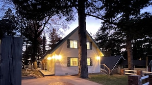 A two-story house with a front porch and a small front yard.