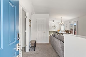 Relax in this open-plan living space with a sofa, dining area, and large window.