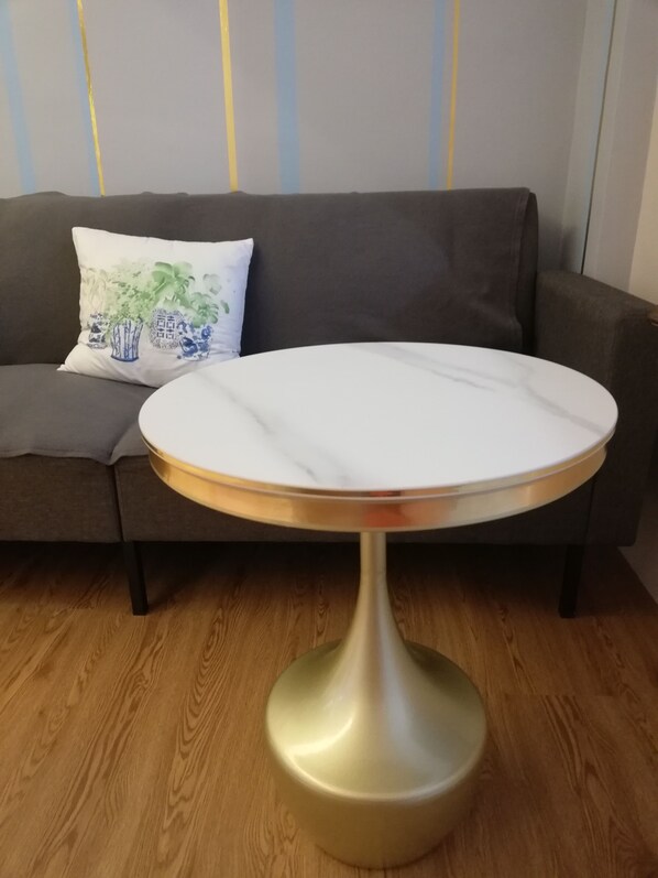 A round table with a white top and a metallic base, placed on a wooden floor. - Ampang Hilir Lakeview (Ampang)