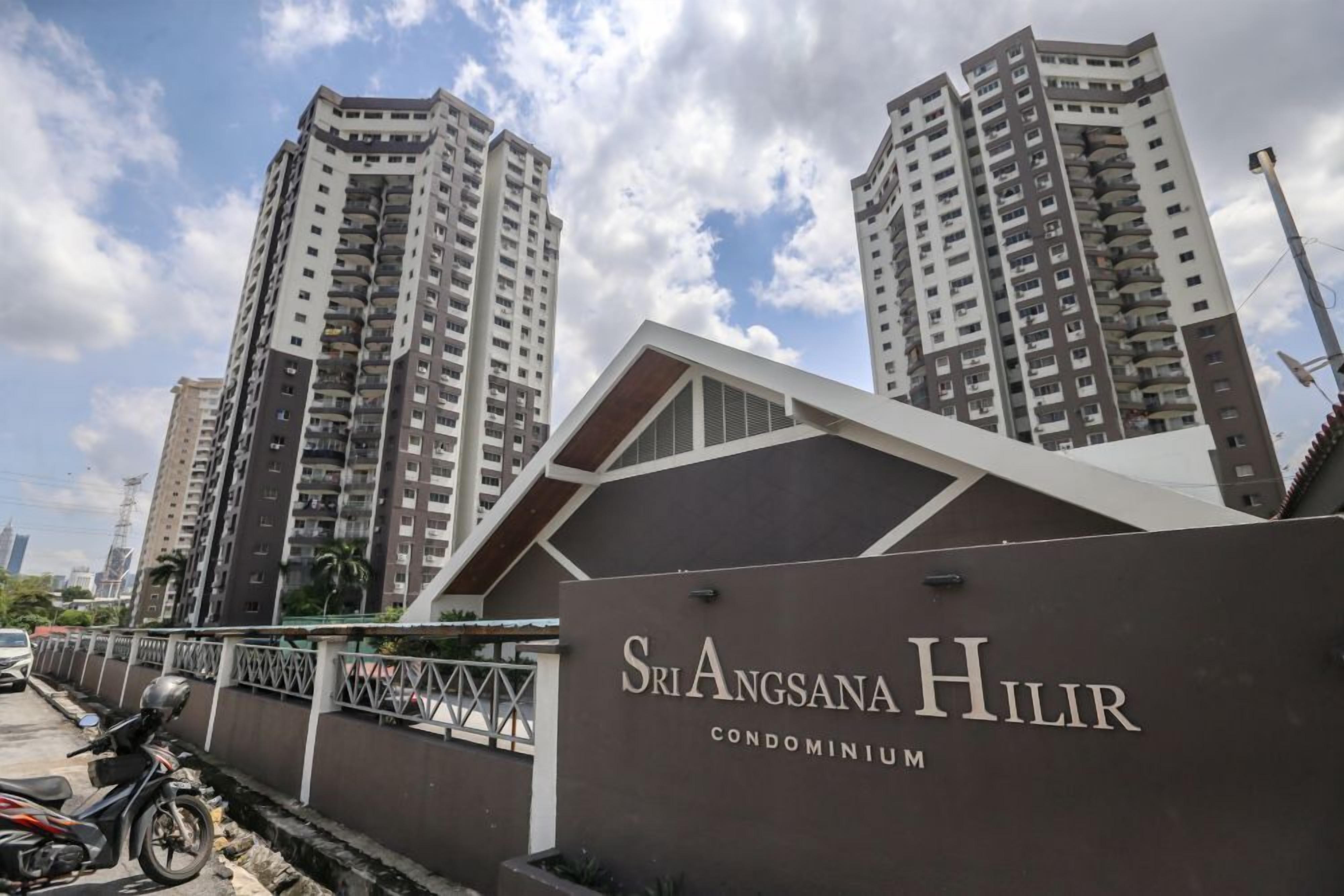 A modern condominium complex with high-rise buildings and a prominent entrance sign.