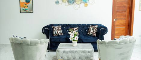 Deluxe Suite, 2 Bedrooms | Living area | 32-inch Smart TV with digital channels