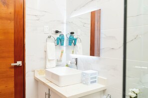 A modern bathroom with a white sink, a mirror, and a towel rack. - Apartament Luxury at Bonao (Bonao)