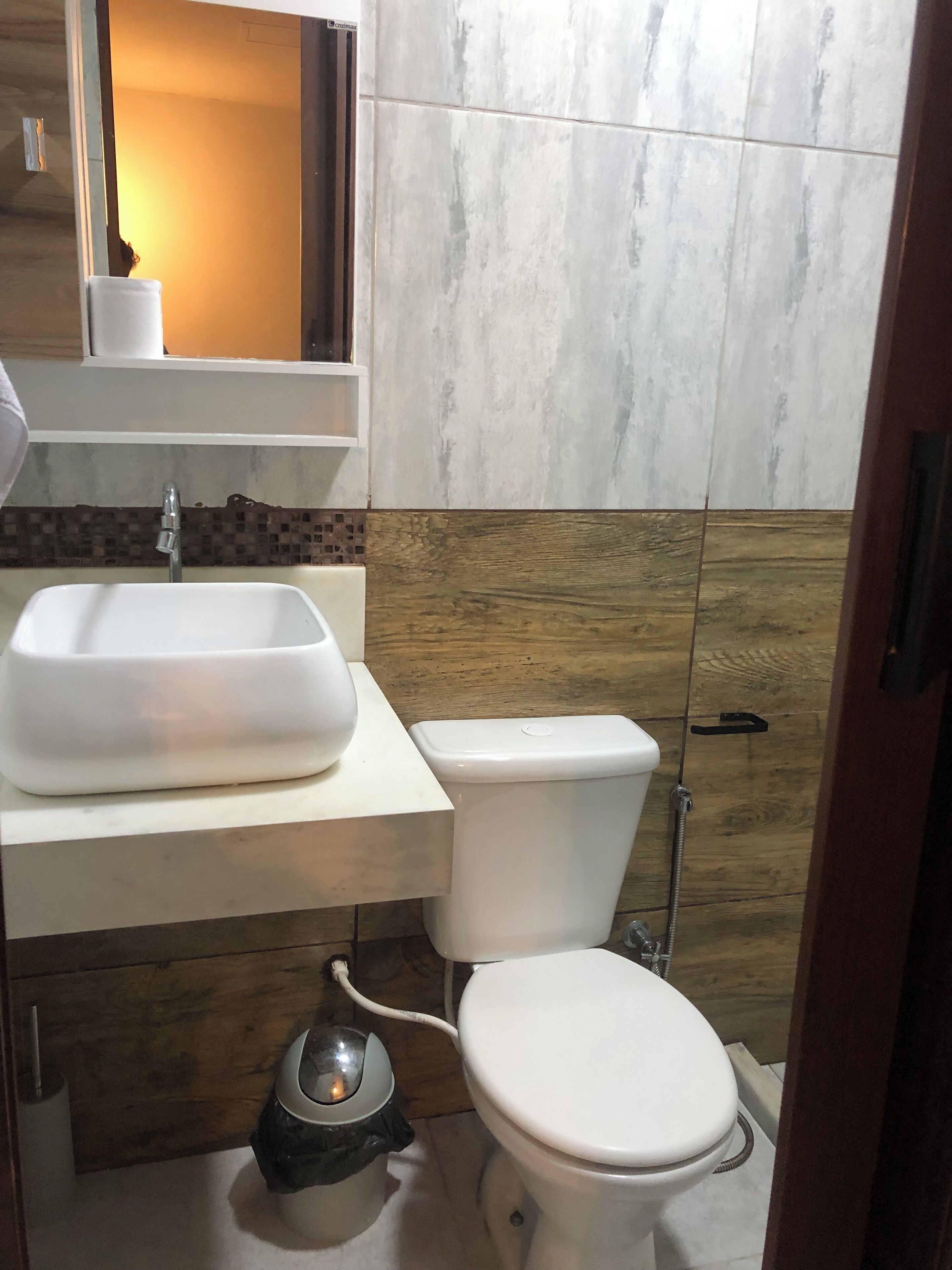 A bathroom with a white sink, toilet, and bidet.
