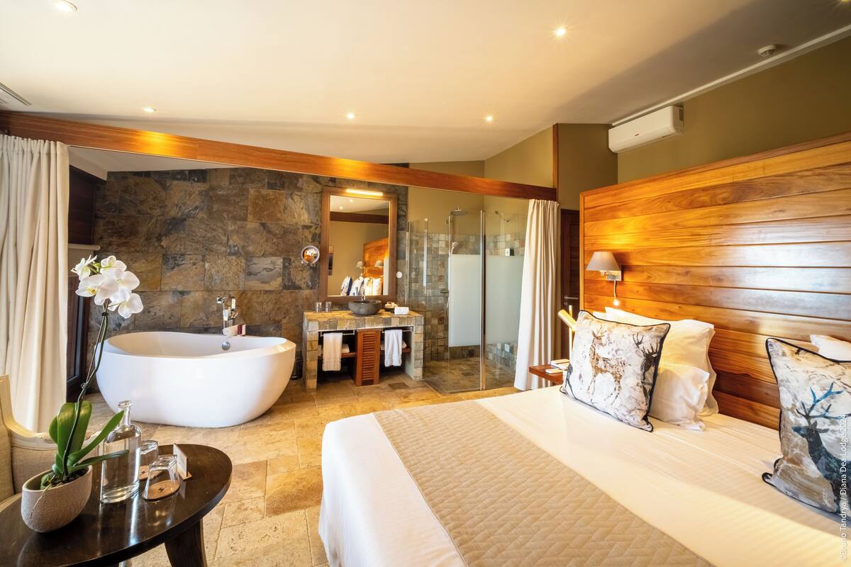 A modern bathroom with a freestanding bathtub, a vanity with a mirror, and a shower area.
