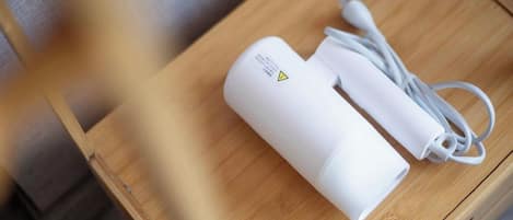 A white portable power bank with a cable on a wooden table.