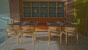 A modern dining area with a long wooden table, six wicker chairs, and a decorative wall with shelves. - Siddhartha Hotel Damauli (Byas)