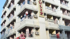 A multi-story hotel with balconies and a prominent sign reading "HOTEL TULIP".