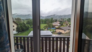 A balcony with a view of a residential area, including houses and a green field. - Le Balandri - Double hotel room (Lully)