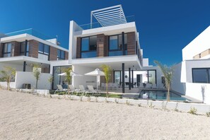 A modern two-story house with a pool, outdoor seating, and a clear blue sky. - Protaras Aqua Pearl Villa Aq10 With Pool Heating (Paralimni)