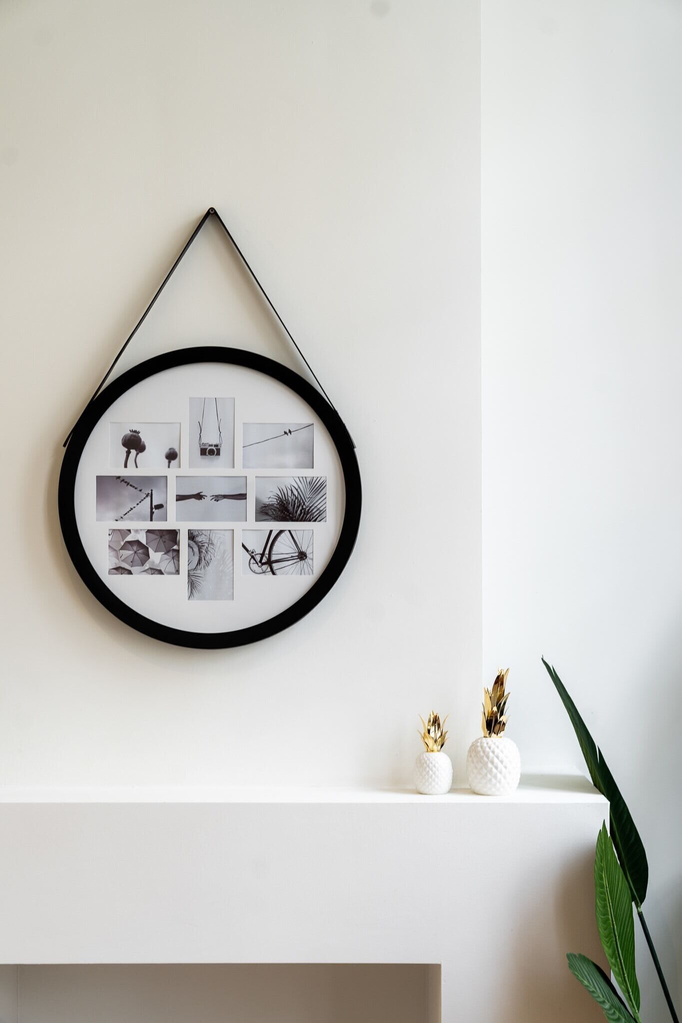 Un collage encadré fixé au mur, composé de différentes photographies en noir et blanc.