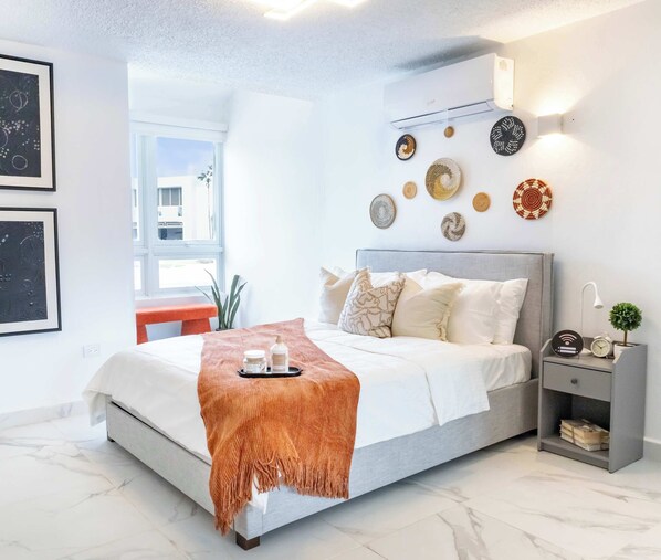 A modern bedroom with a bed, bedside table, and wall decor. - AQUA Casa A/8 Rm 3 · Bedroom in Dorado del Mar (Dorado)