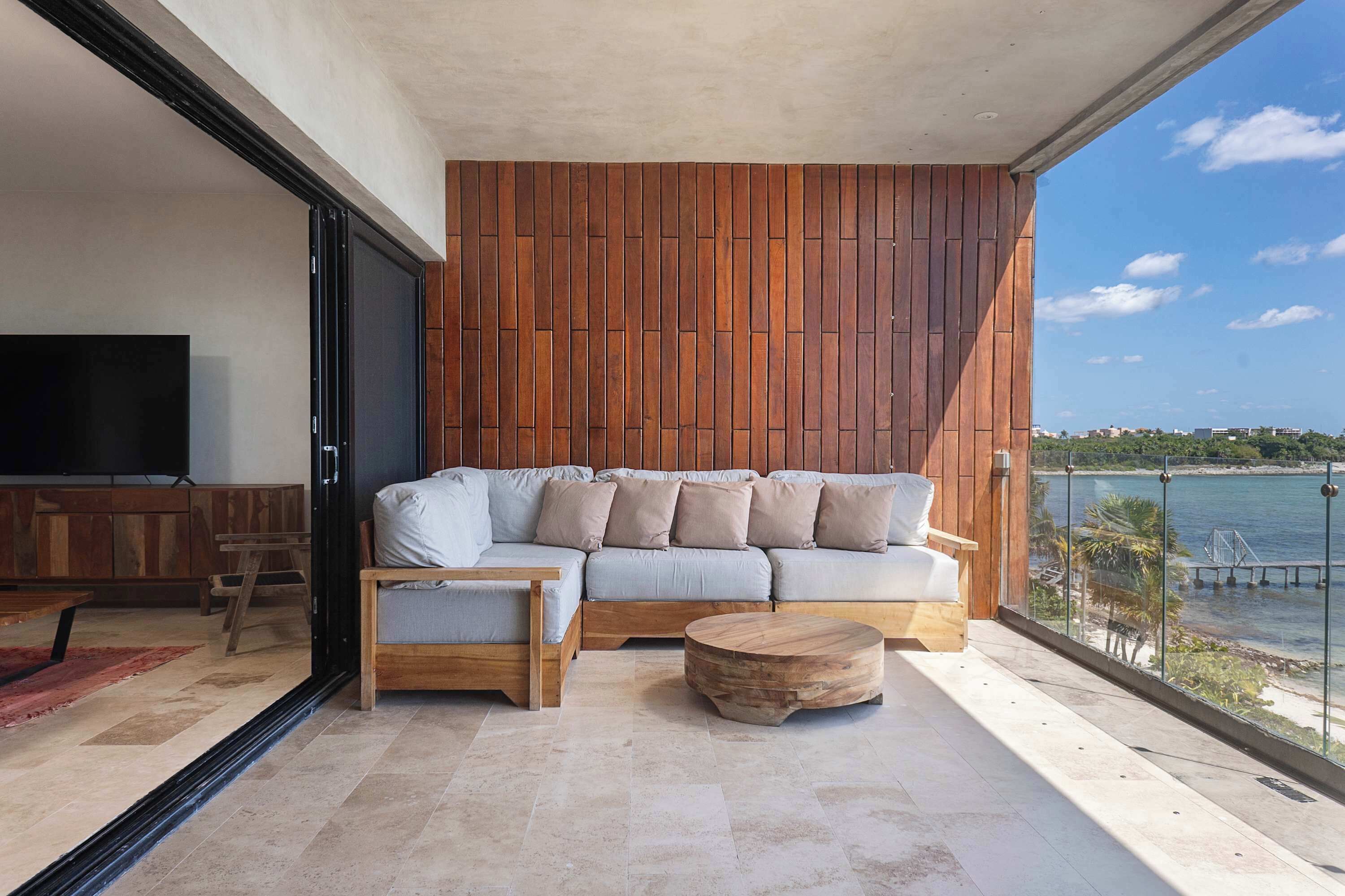 A modern living room with a sofa, a coffee table, and a TV.