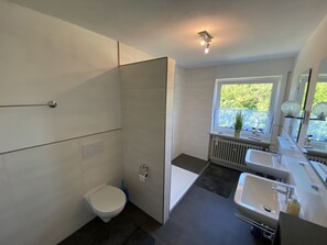 Shower, hair dryer, towels, toilet paper