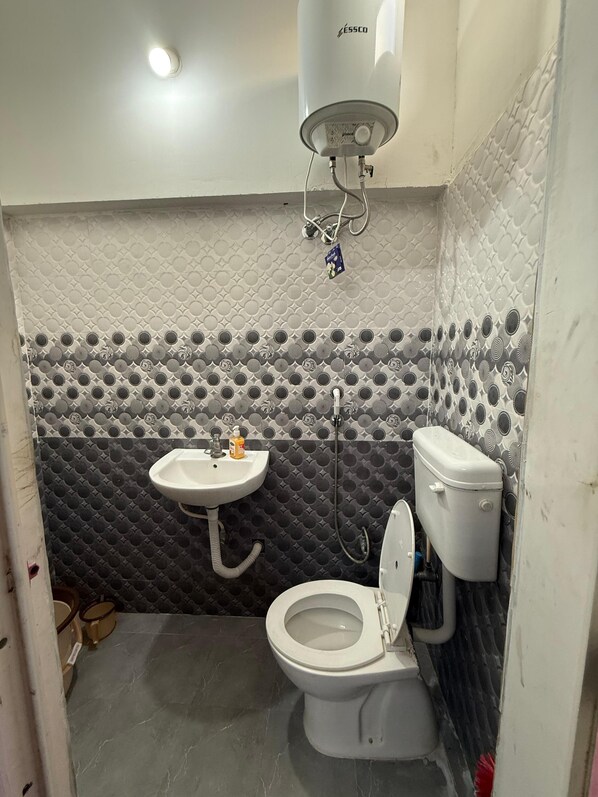 A bathroom with a toilet, sink, and shower. - ILFORD CASTLE HOME STAY PONDICHERRY (Vanur)